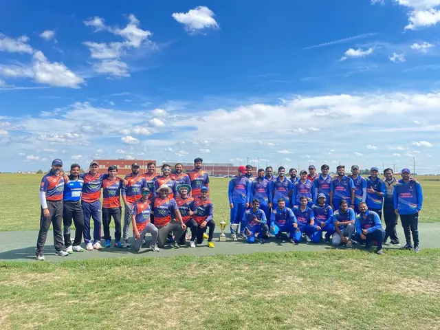 Cricket teams standing together on an outdoor field beneath a blue sky.